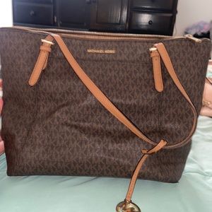 Brown leather Michael Kors large tote purse and wallet.